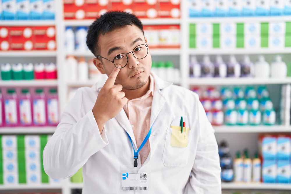 Chinese young man in pharmacy